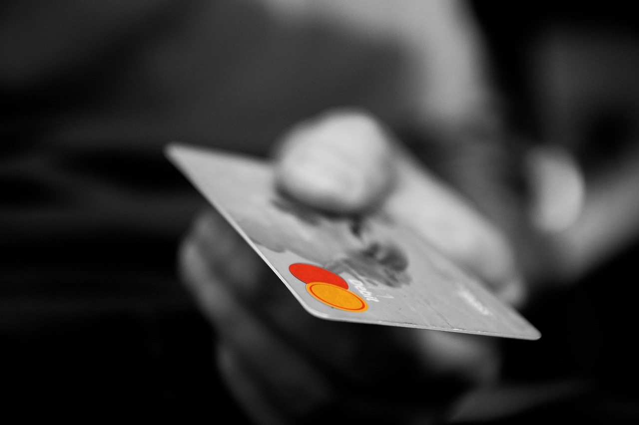 Hand holding a credit card with highlighted logo